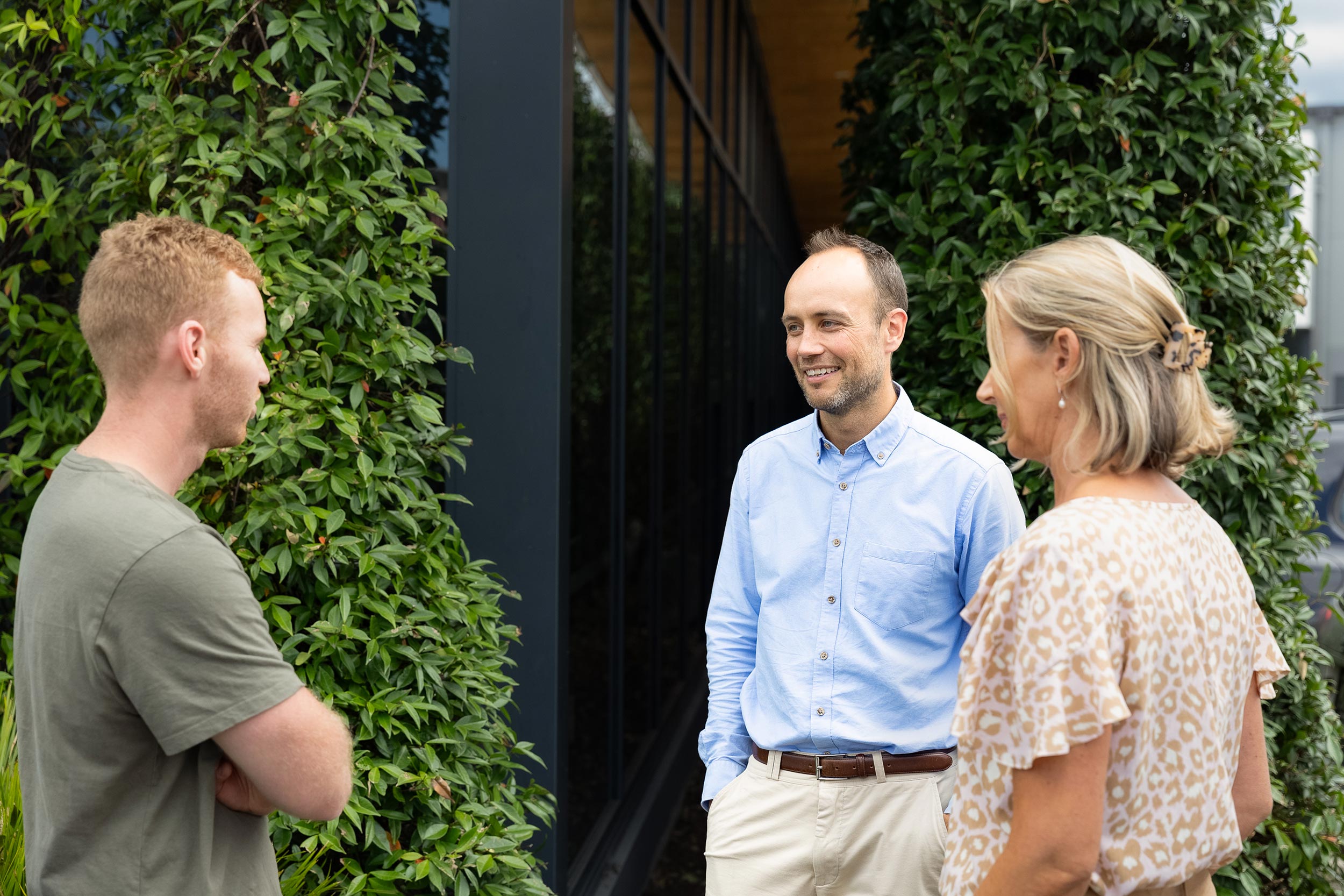 Lawyer and clients standing outside in discussion